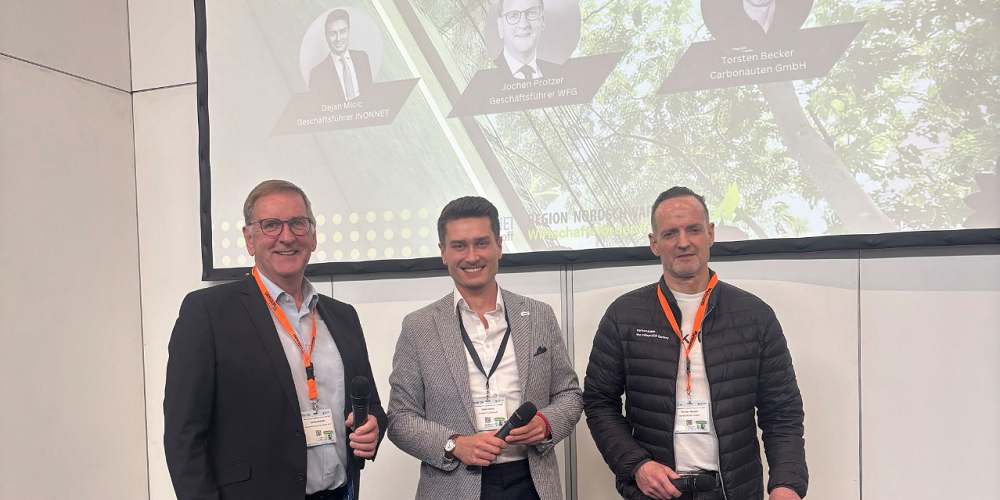 Bild von drei Personen auf der Bühne.